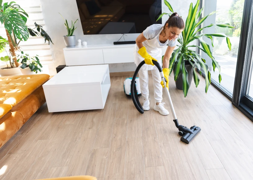 Woman vacuuming a modern living room