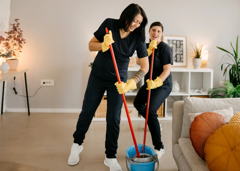 Women mopping floor in living room