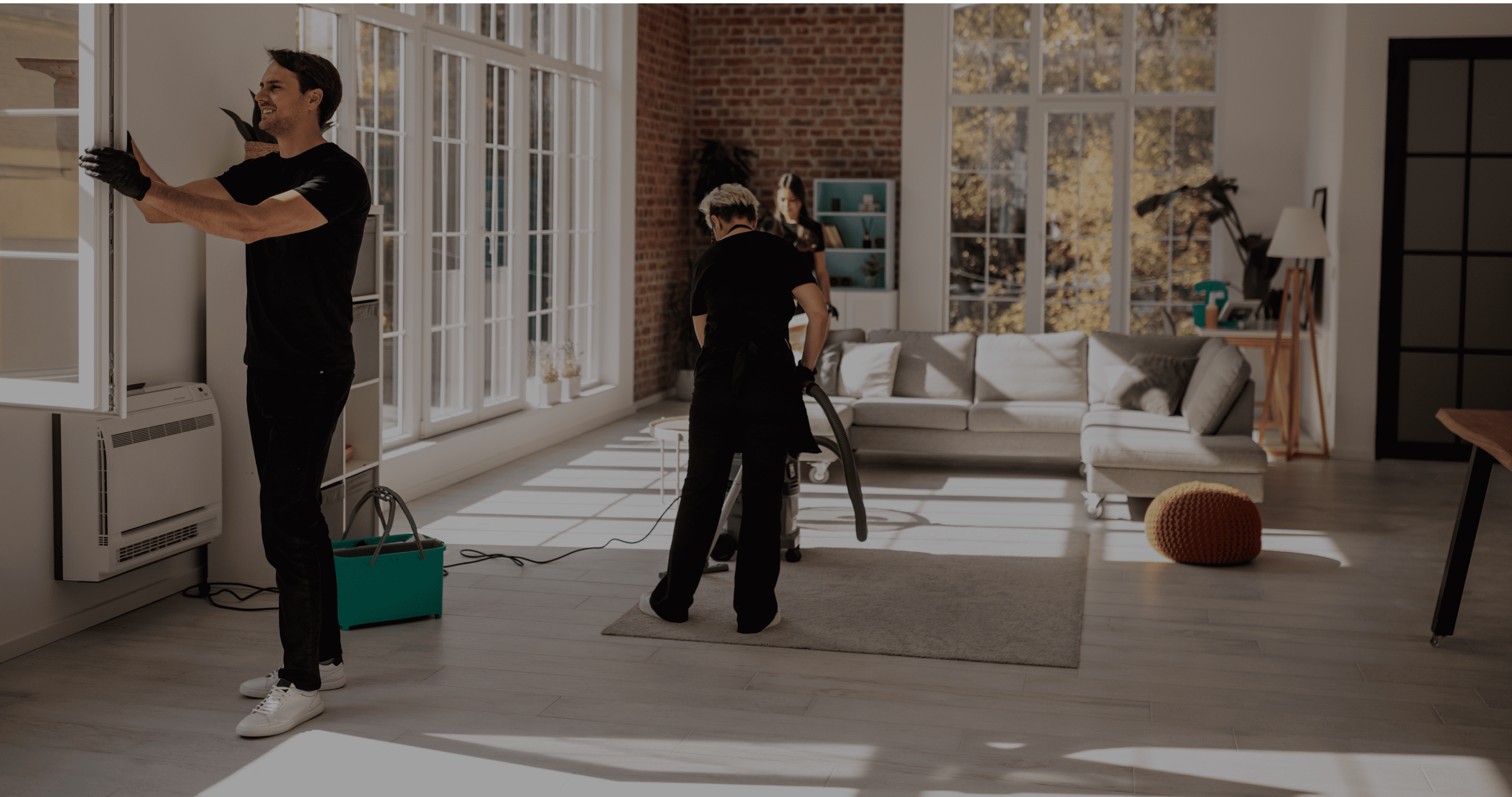 Two people setting up a camera in a bright, modern living room.