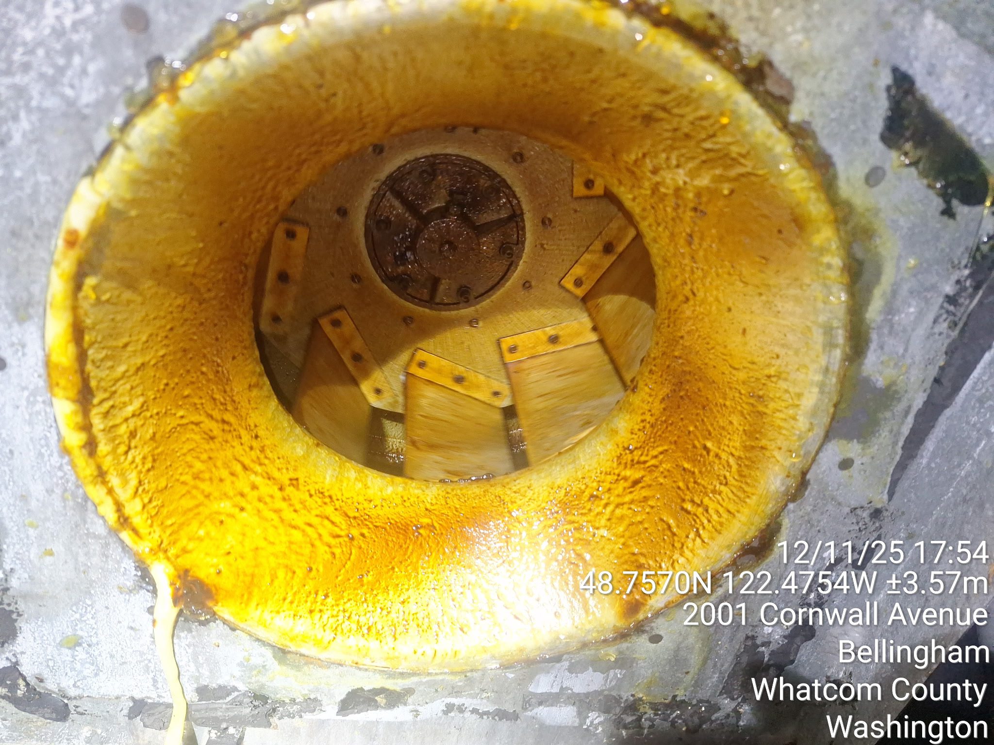 Close-up of a yellow industrial machine part with gears inside.