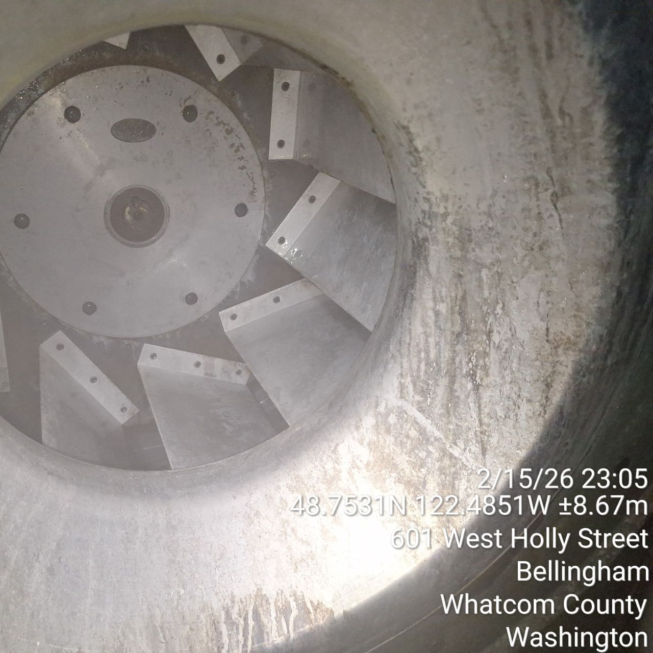 Interior view of a large industrial fan or turbine with visible blades.