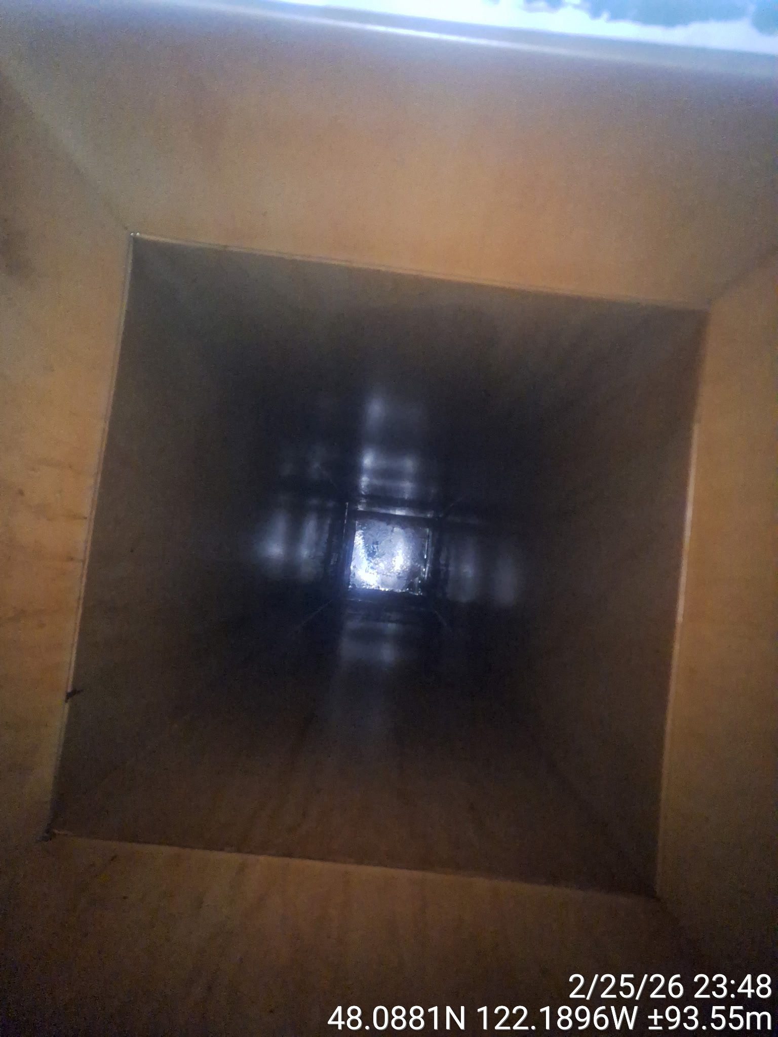 Dark empty cardboard box with light at the far end.
