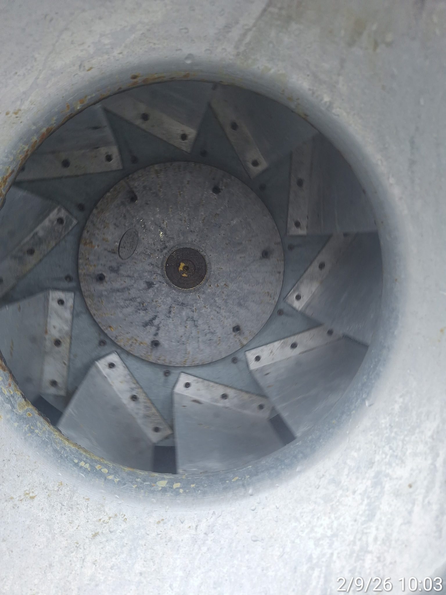 Close-up of a metal centrifugal fan with multiple blades.