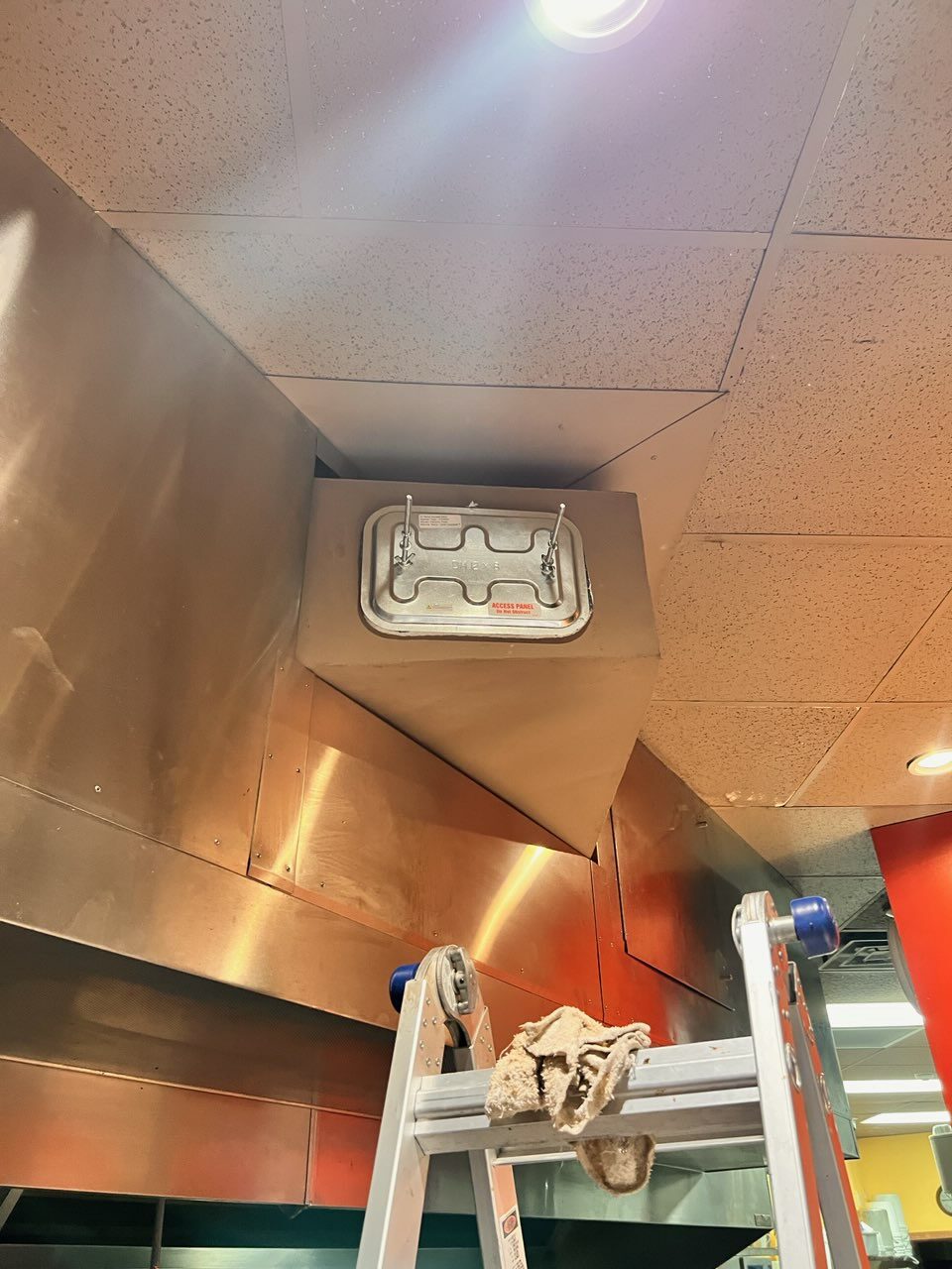 Upside-down pizza box on a restaurant ceiling.