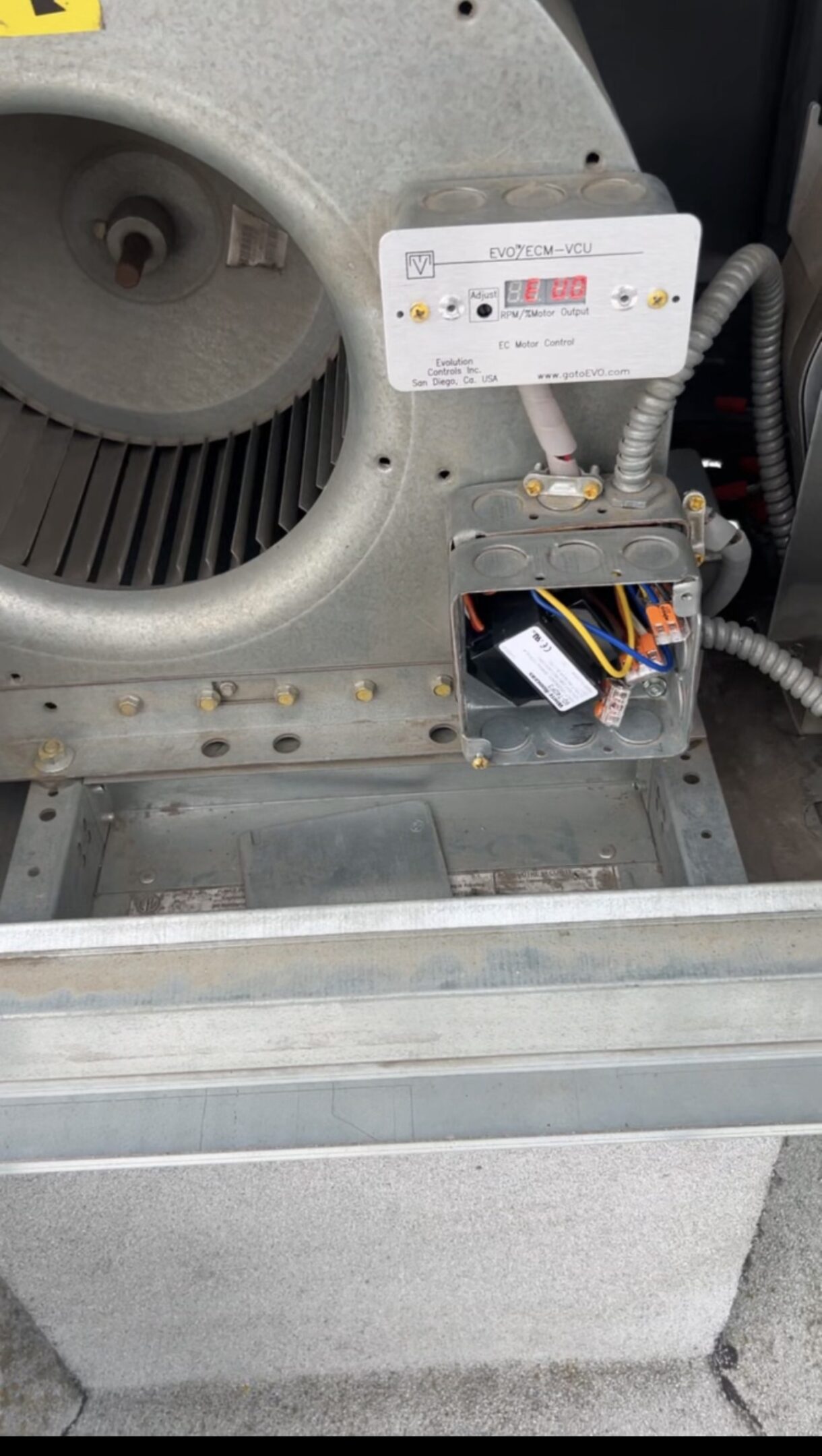 Close-up of a mechanical component with wires and a fan.